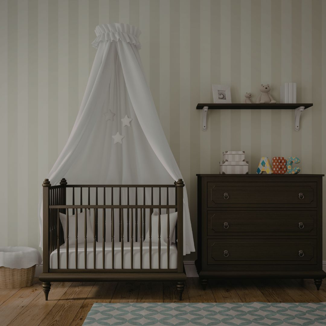 Nursery room with wooden crib, canopy, and dresser against striped wallpaper.